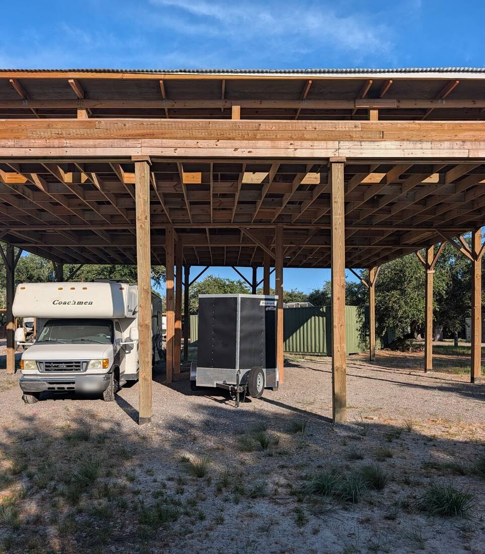 Motorhome and enclosed trailer parked in the 15-foot oversize covered building